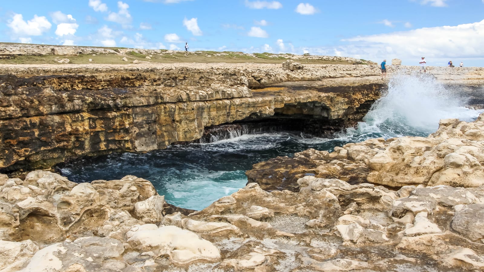 The natural limestone arch of Devil’s Bridge on Antigua’s Atlantic coast