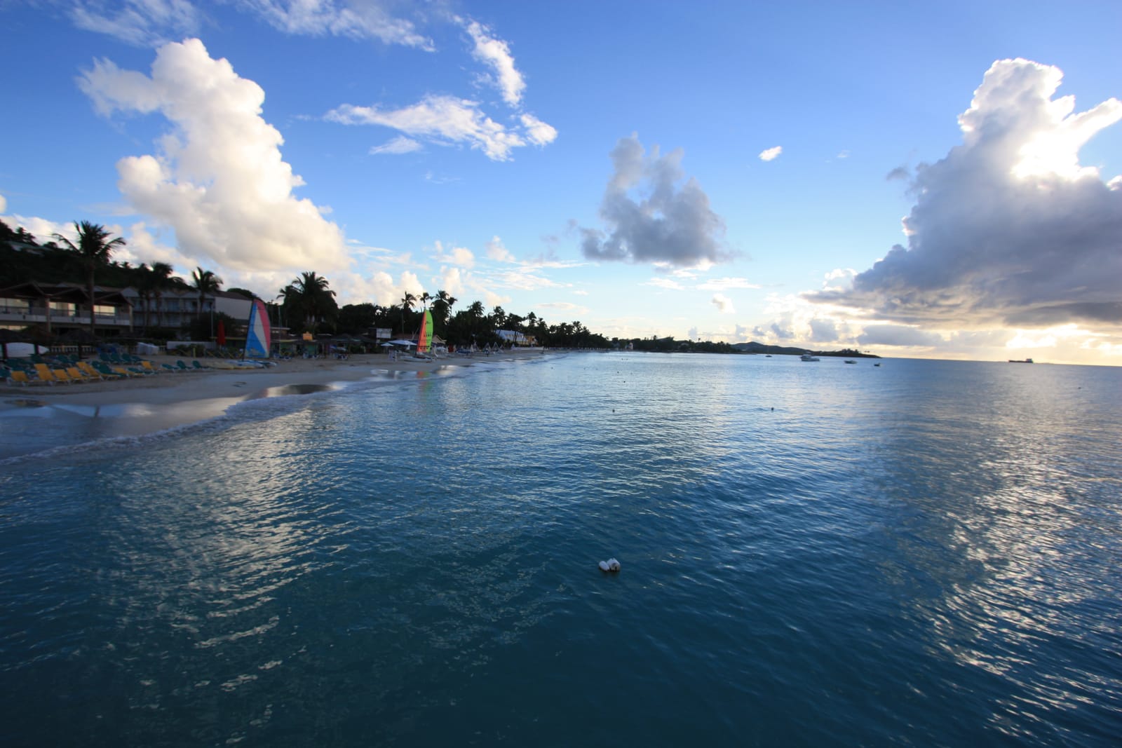 The long pale sand crescent and calm water of Dickenson Bay, Antigua
